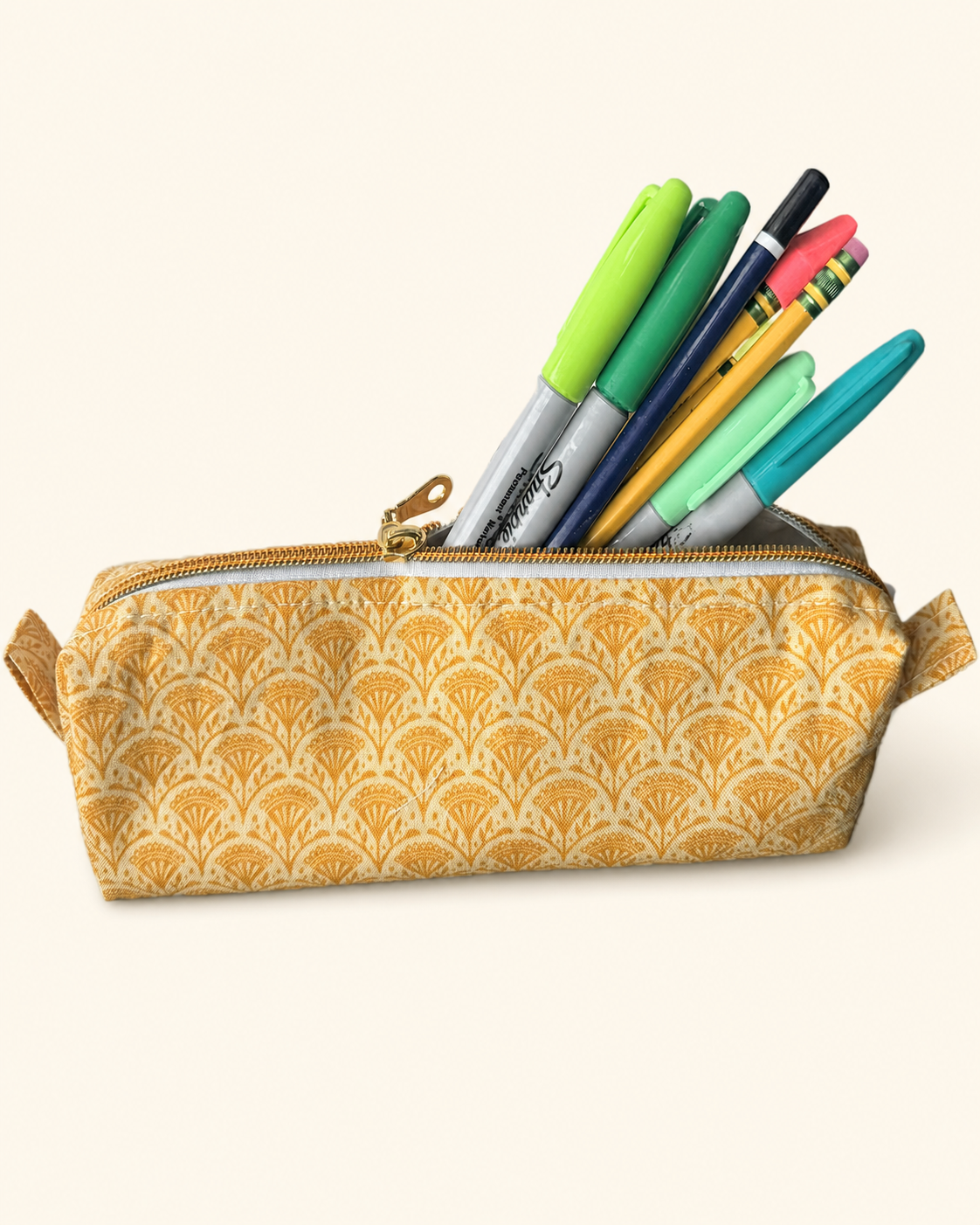 Yellow patterned Perfect Pencil pouch filled with writing tools